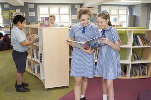 St Pius Catholic Primary School Enmore - students looking at books in the library